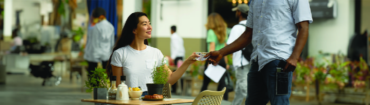 woman-paying-with-cash-at-street-cafe-100
